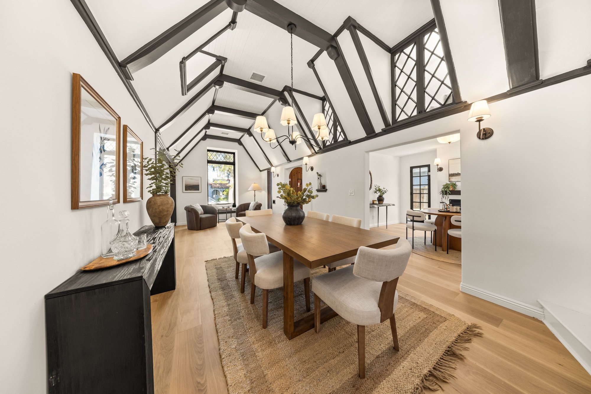 Living and dining room at 1941 Midvale Ave: vaulted Tudor ceiling with dark beams and leaded-glass windows